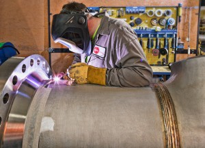 Team Industry welder welding a pipe.